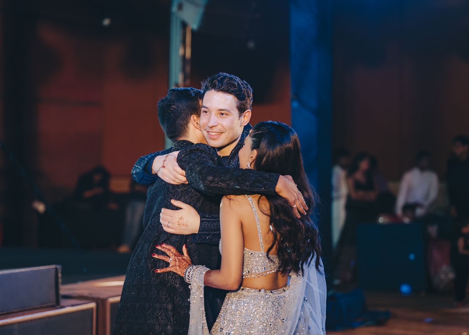 Elegant reception venue with romantic mood lighting and dancing couples.