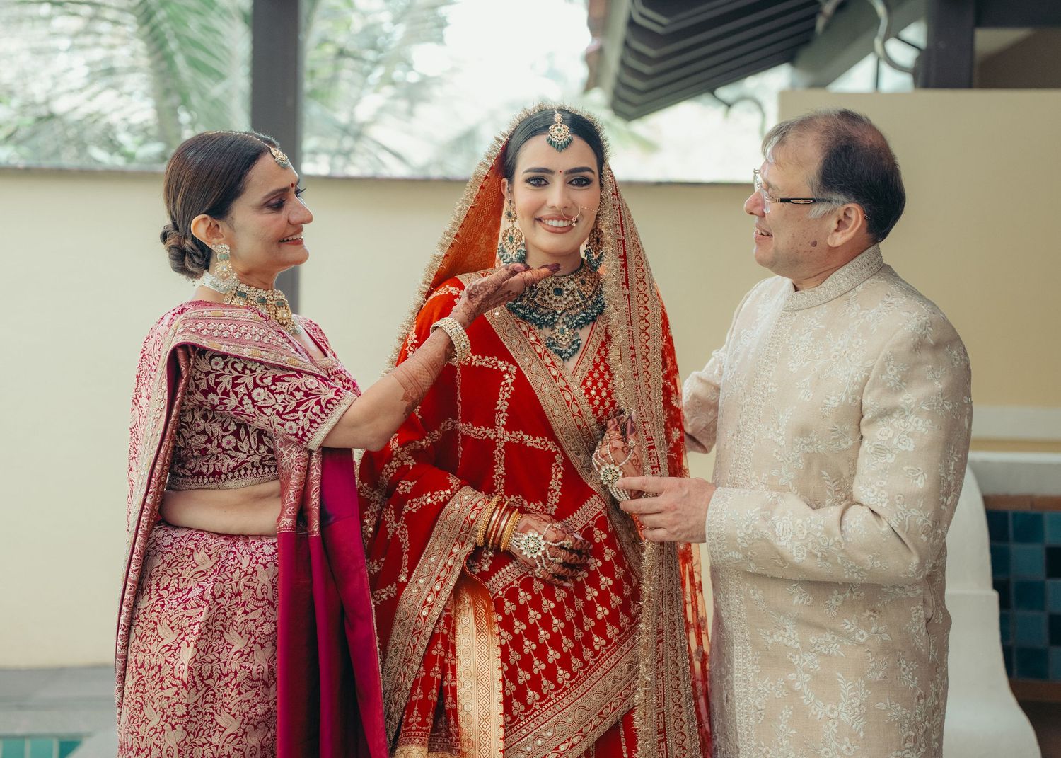 A traditional Indian wedding ceremony showing participants in elegant bridal and cultural attire during an intimate moment.
