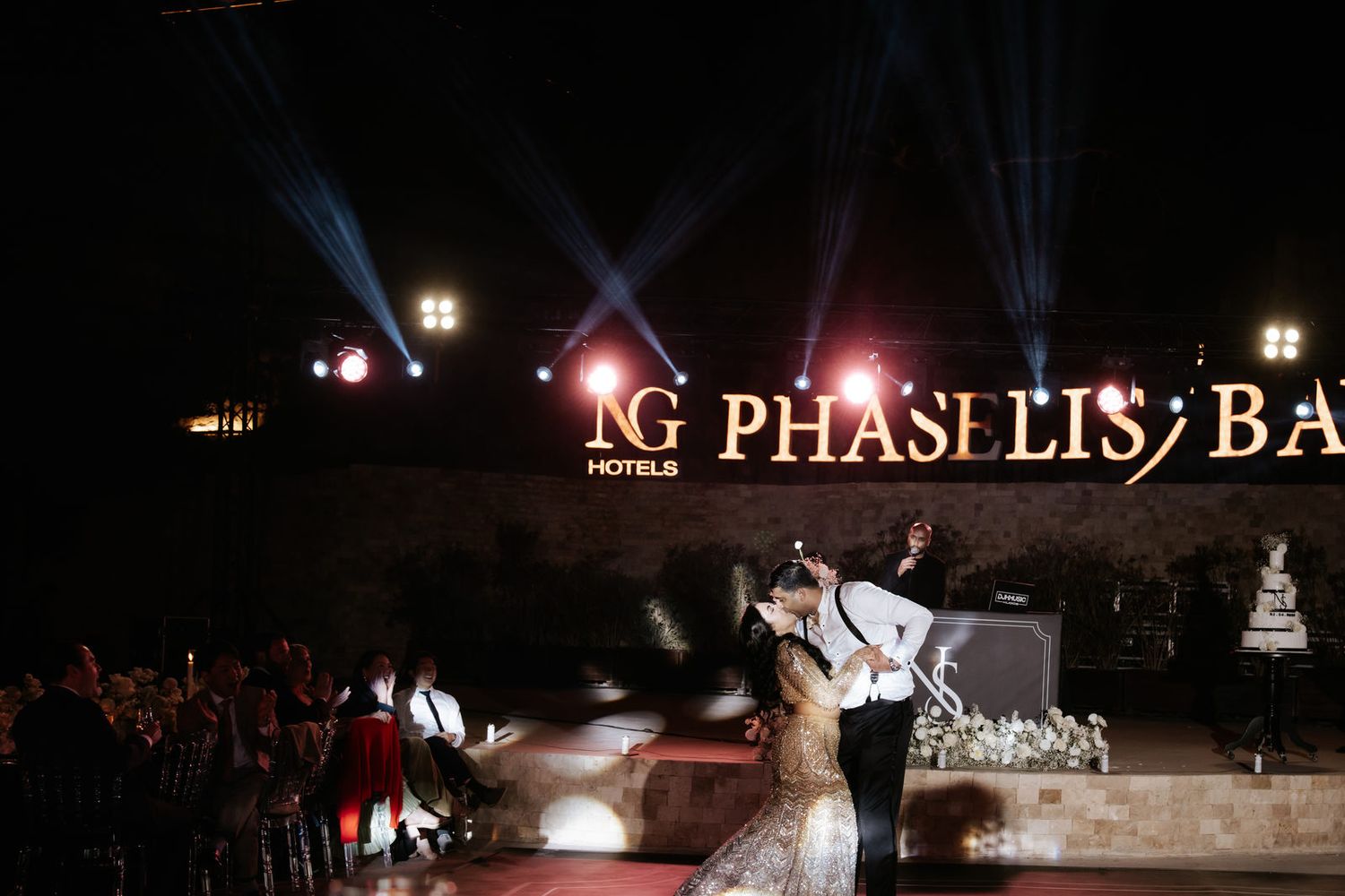 Indian couple sharing romantic first dance under dramatic stage lights at NG Phaselis Bay hotel wedding.