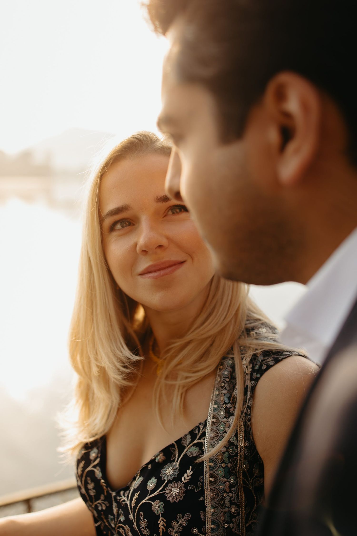 A romantic golden hour portrait session with soft sunlight illuminating the couple.