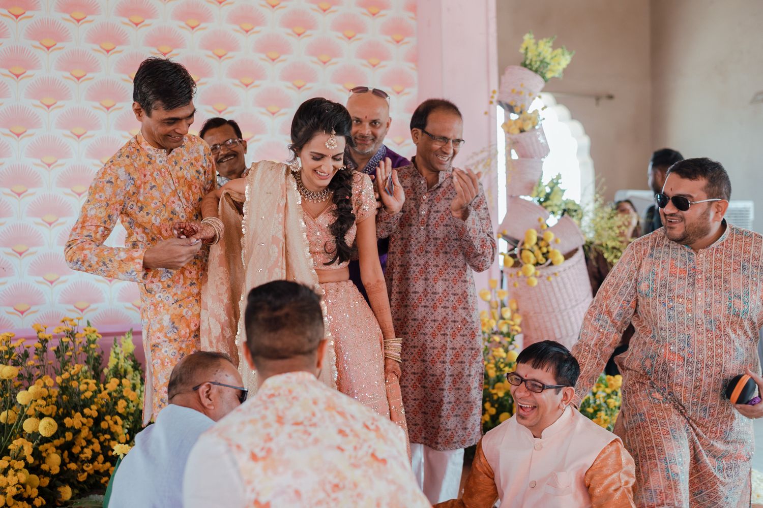A collection of soft pink-toned candid moments from a romantic wedding celebration gathering.