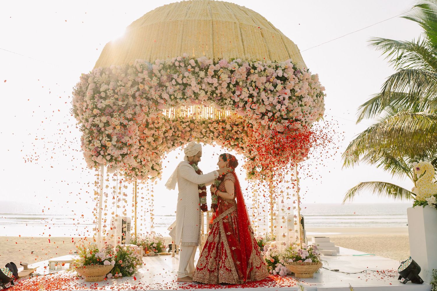 An elegant wedding ceremony setup with floral decorations and confetti effects.