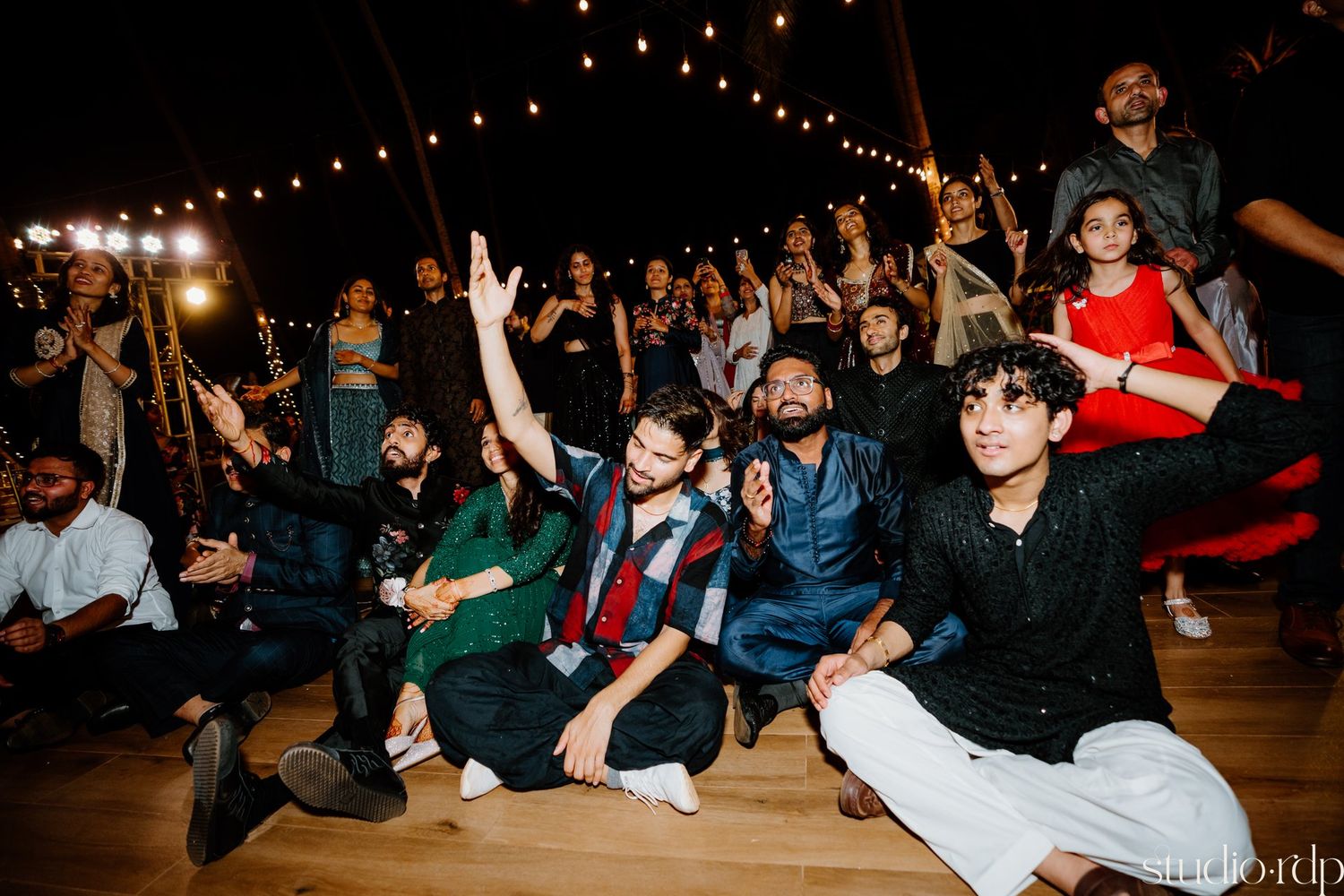 Party guests strike playful poses on the dance floor during an energetic celebration.