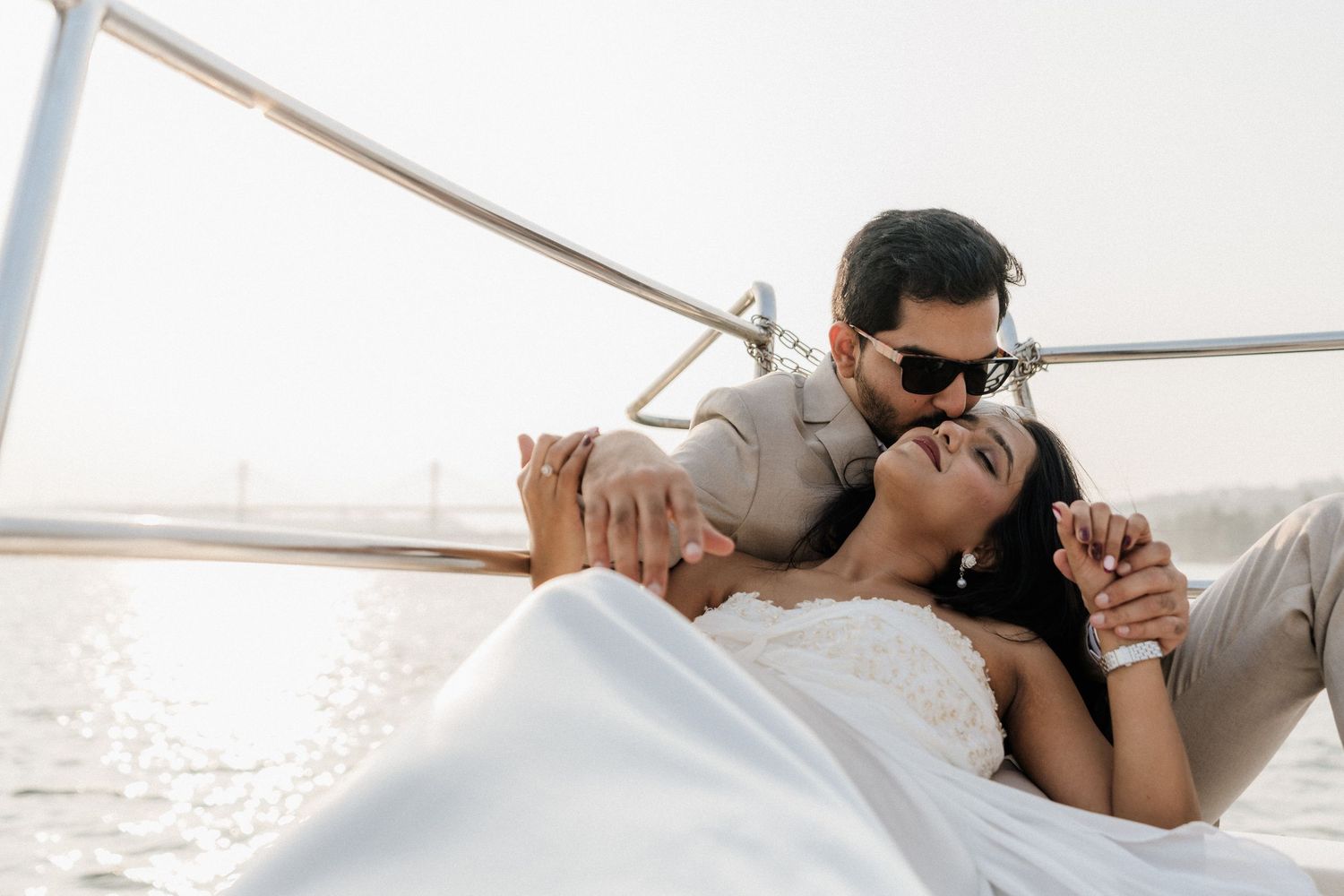 Beachside pre wedding couple in white outfits enjoying intimate moments during a tropical Goa photoshoot by Studio RDP
