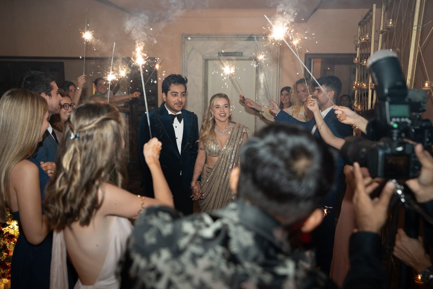 Wedding reception celebration with sparklers creating a magical atmosphere on the dance floor.