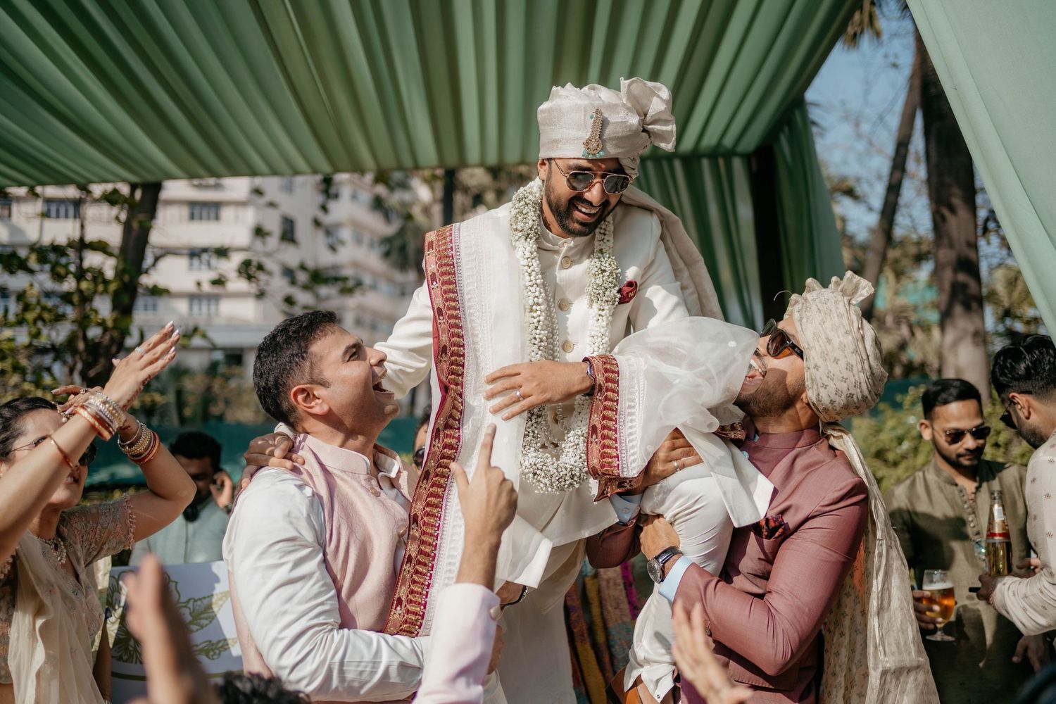 People celebrating together at an intimate outdoor gathering, exchanging emotional moments in a garden setting.