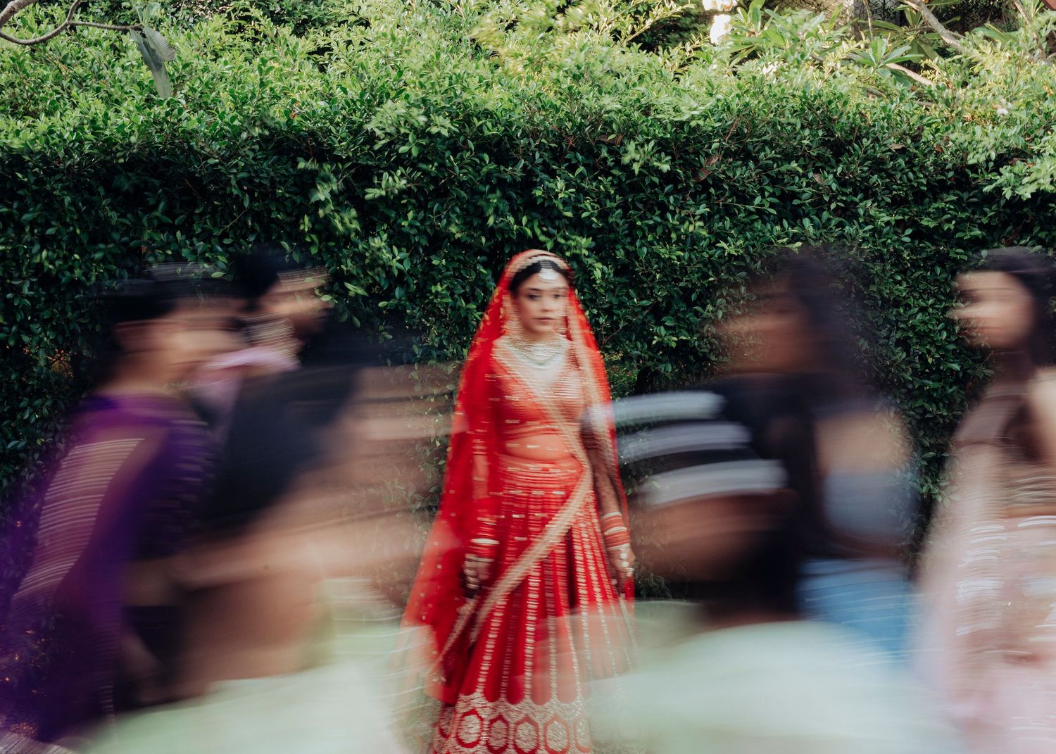 Bride Juhi twirls in a red traditional lehenga during an outdoor wedding moment at Avani Hua Hin, captured by Studio RDP