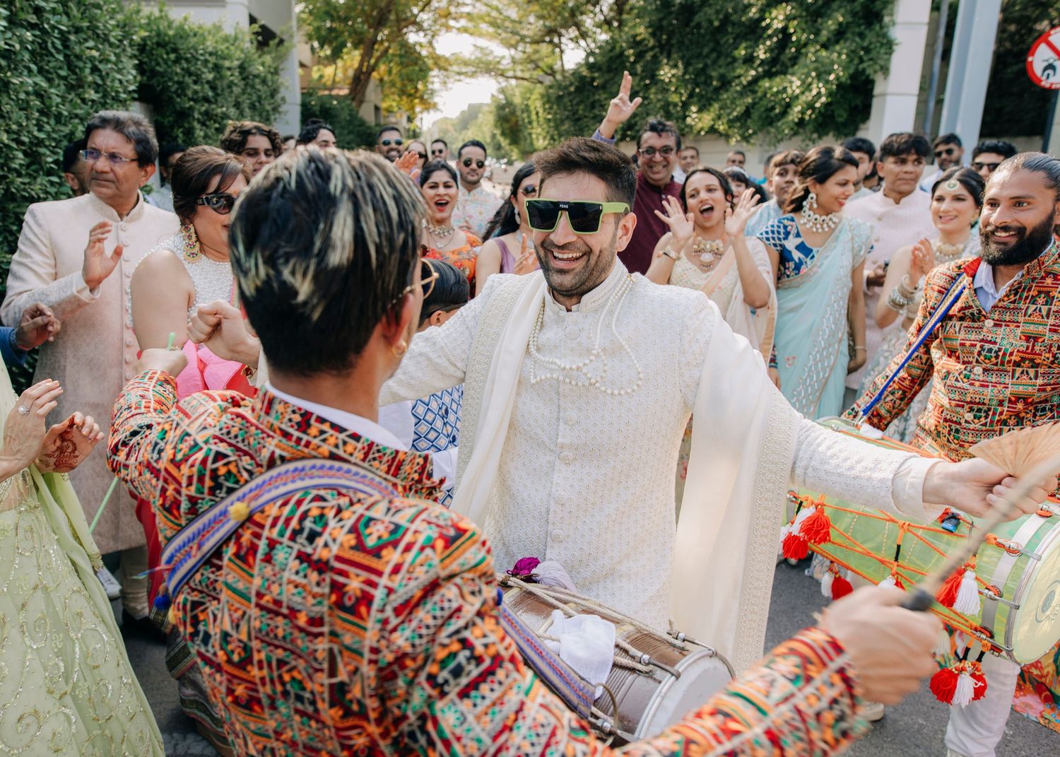 A collage of people celebrating at an outdoor wedding party with festive decorations and colorful attire.