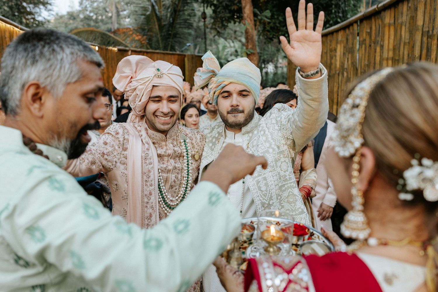 Guests celebrate at an elegant outdoor wedding reception with festive decor and traditional attire.