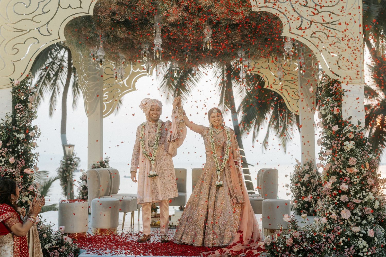 Traditional wedding ceremony setup with floral archway and elegant decor.