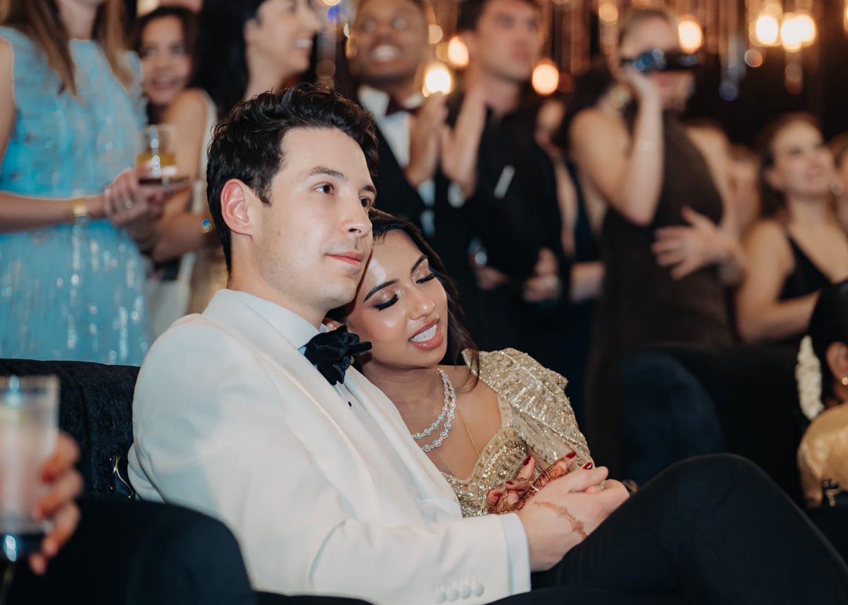 A romantic dance moment captured during a wedding reception with ambient lighting.