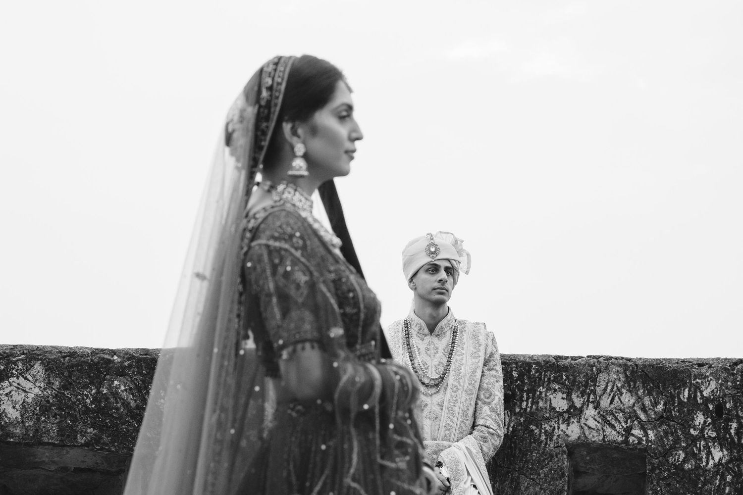 Elegant black and white wedding portrait with traditional Indian bridal attire.