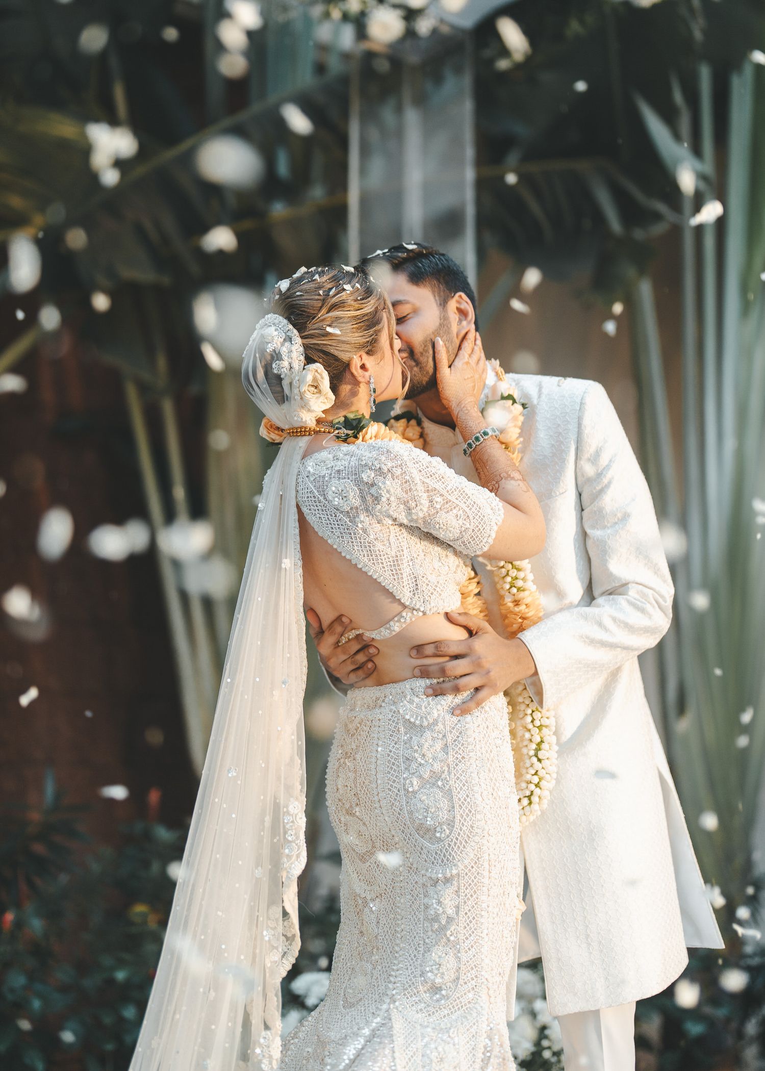 Romantic wedding moments captured with falling confetti in an elegantly decorated venue.