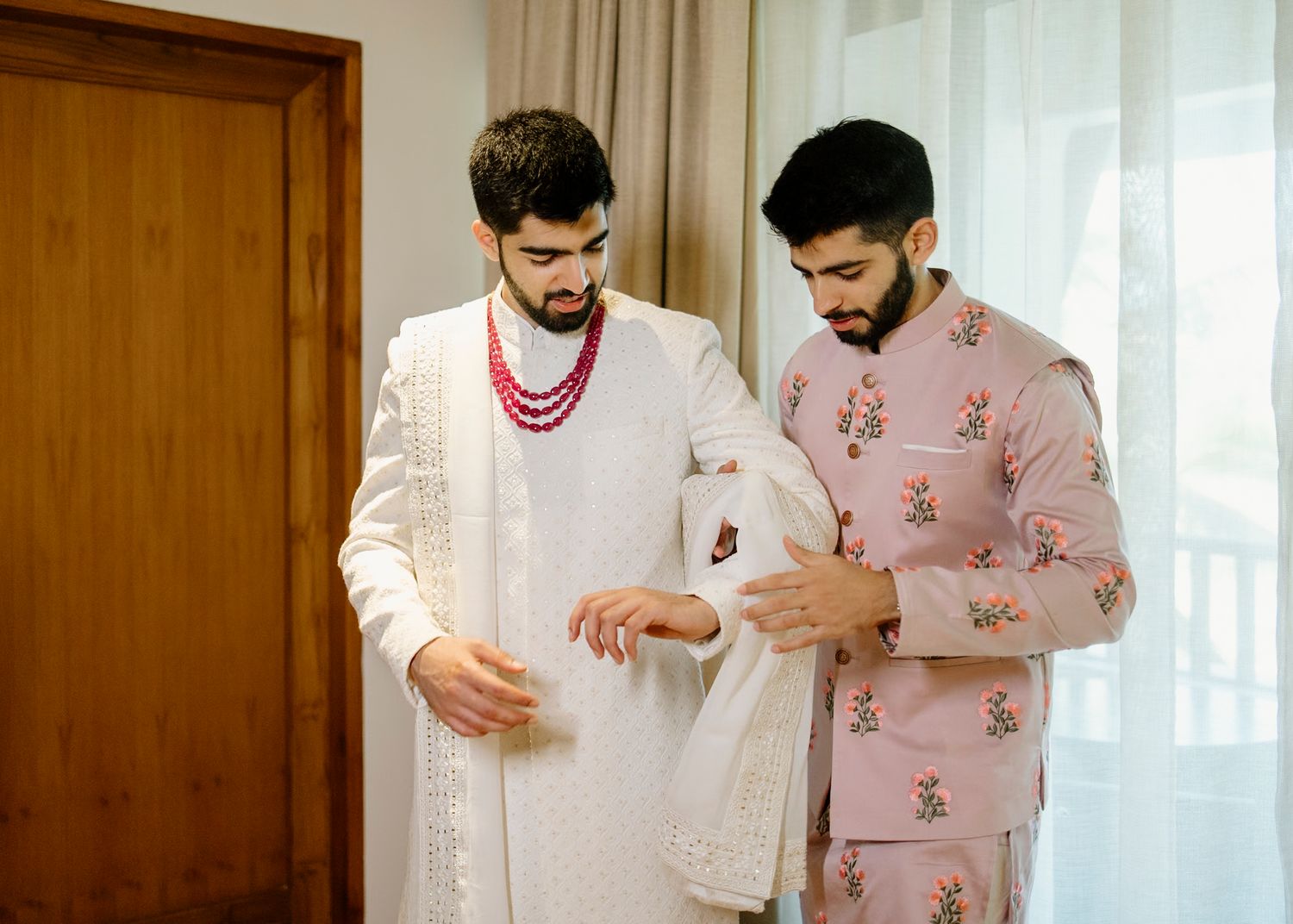 Wedding preparation scene with traditional attire and decor in warm indoor lighting.