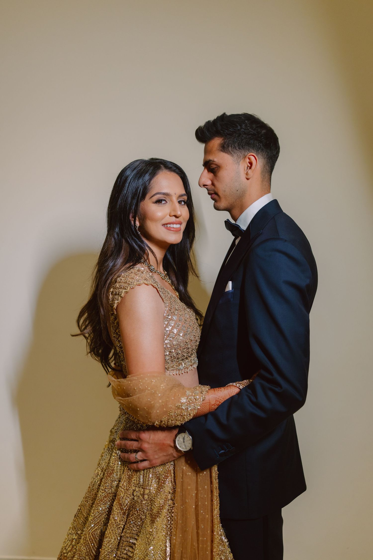 Couple in formal wear sharing tender moments during celebration.