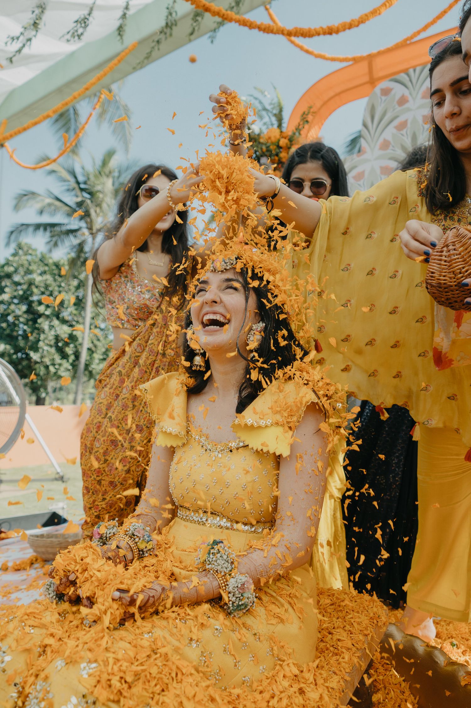 A joyful celebration during a traditional Haldi ceremony with turmeric powder being showered in bright yellow festivities.