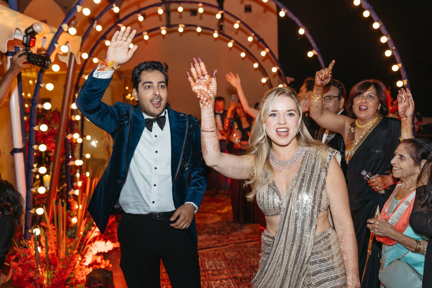 Evening celebration with string lights and guests dancing on a festively decorated dance floor.