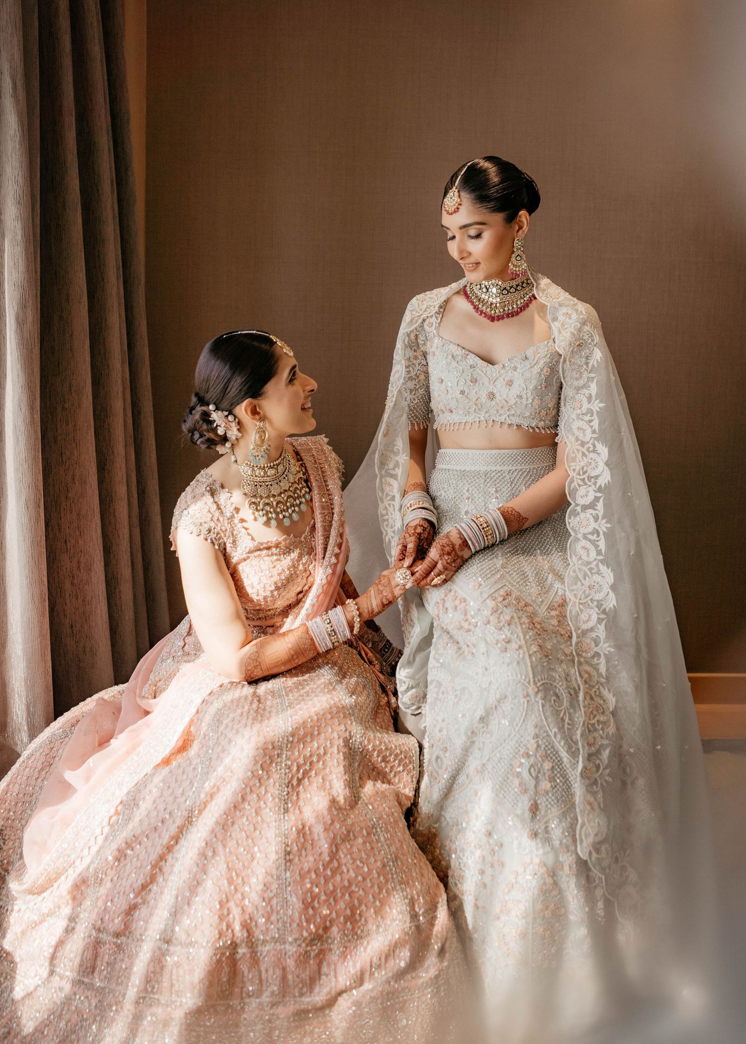 Bridal fashion portrait of Nastasia wearing a blush pink lehenga and white wedding gown at Taj Lands End Mumbai, photographed by Studio RDP