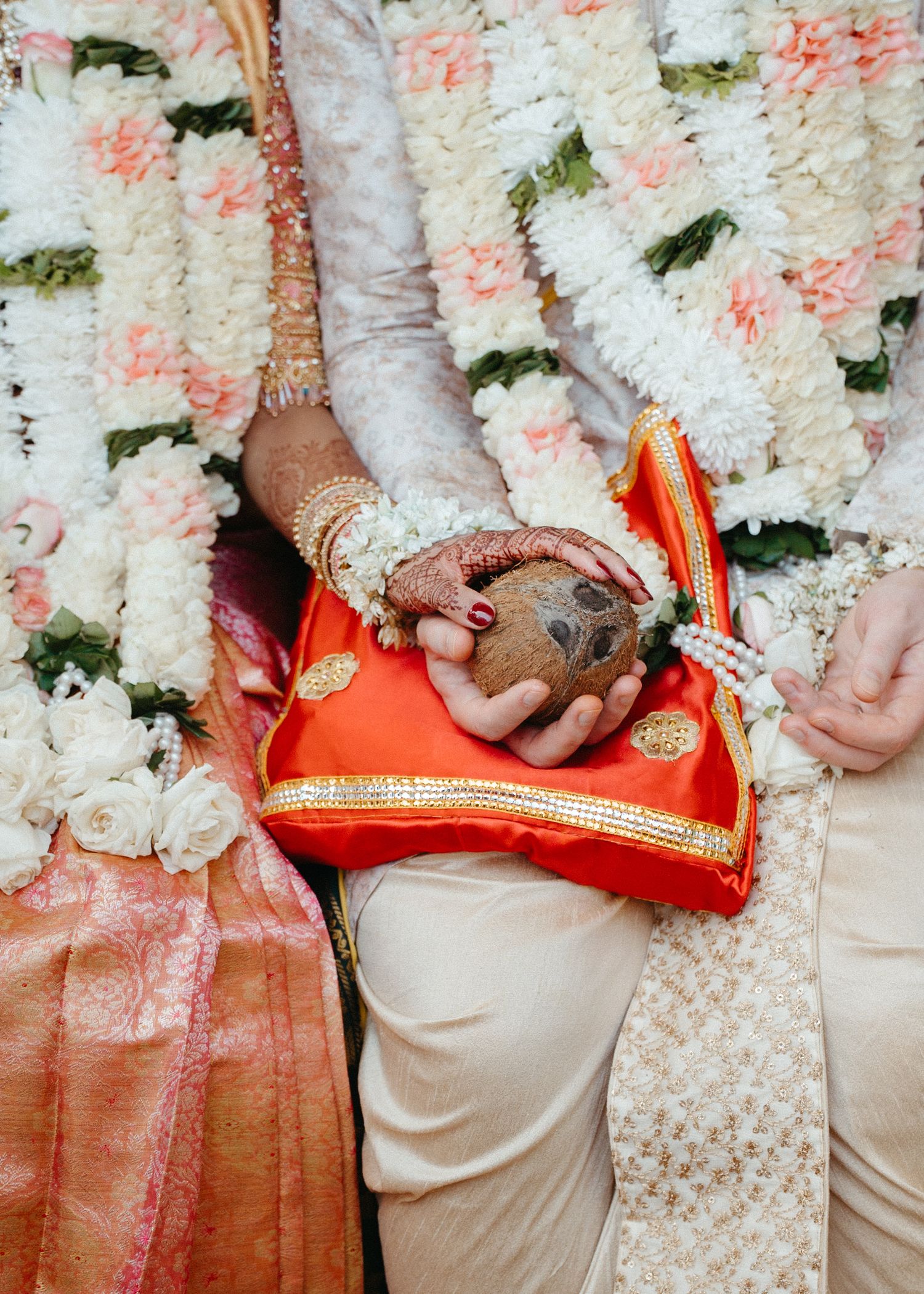 Close-up details of traditional Indian wedding attire and decorative elements.