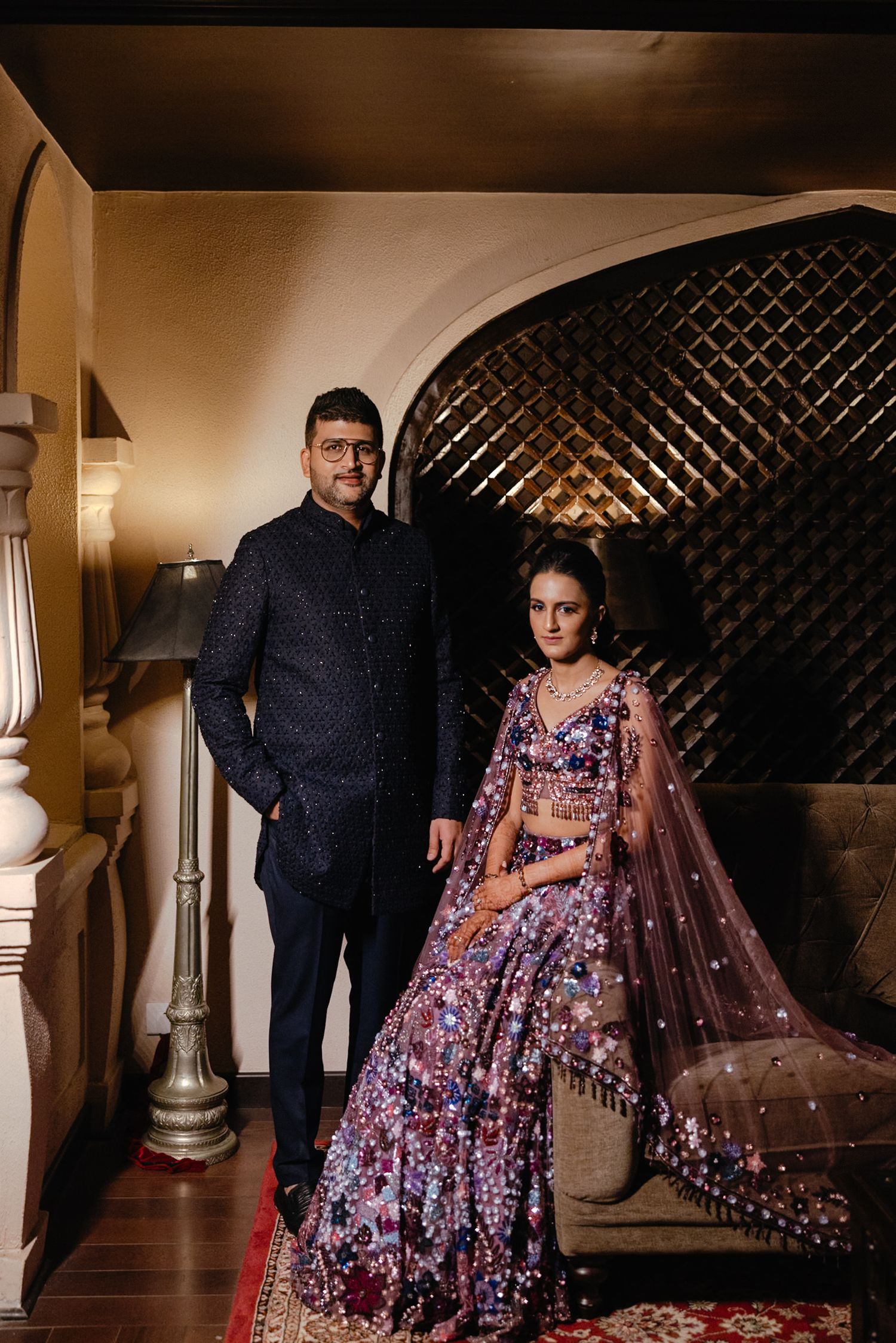 A romantic evening photography series featuring a couple in formal attire with a glittering gown and tulle cape.