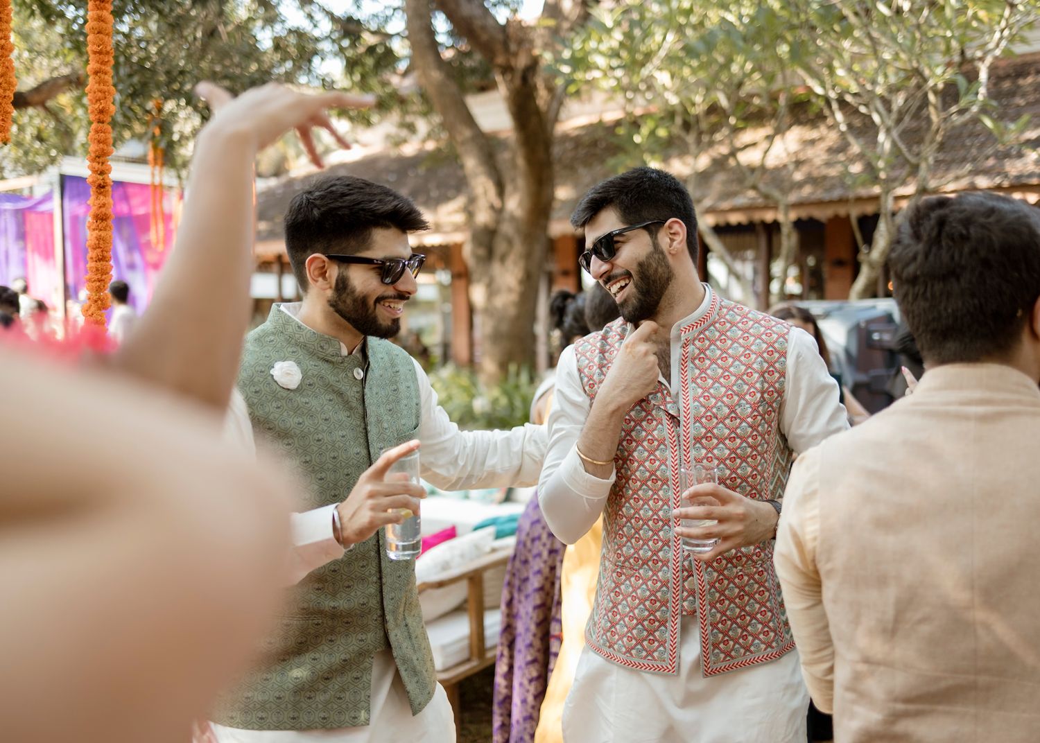 Festive celebration with guests in traditional Indian attire enjoying the outdoor event.