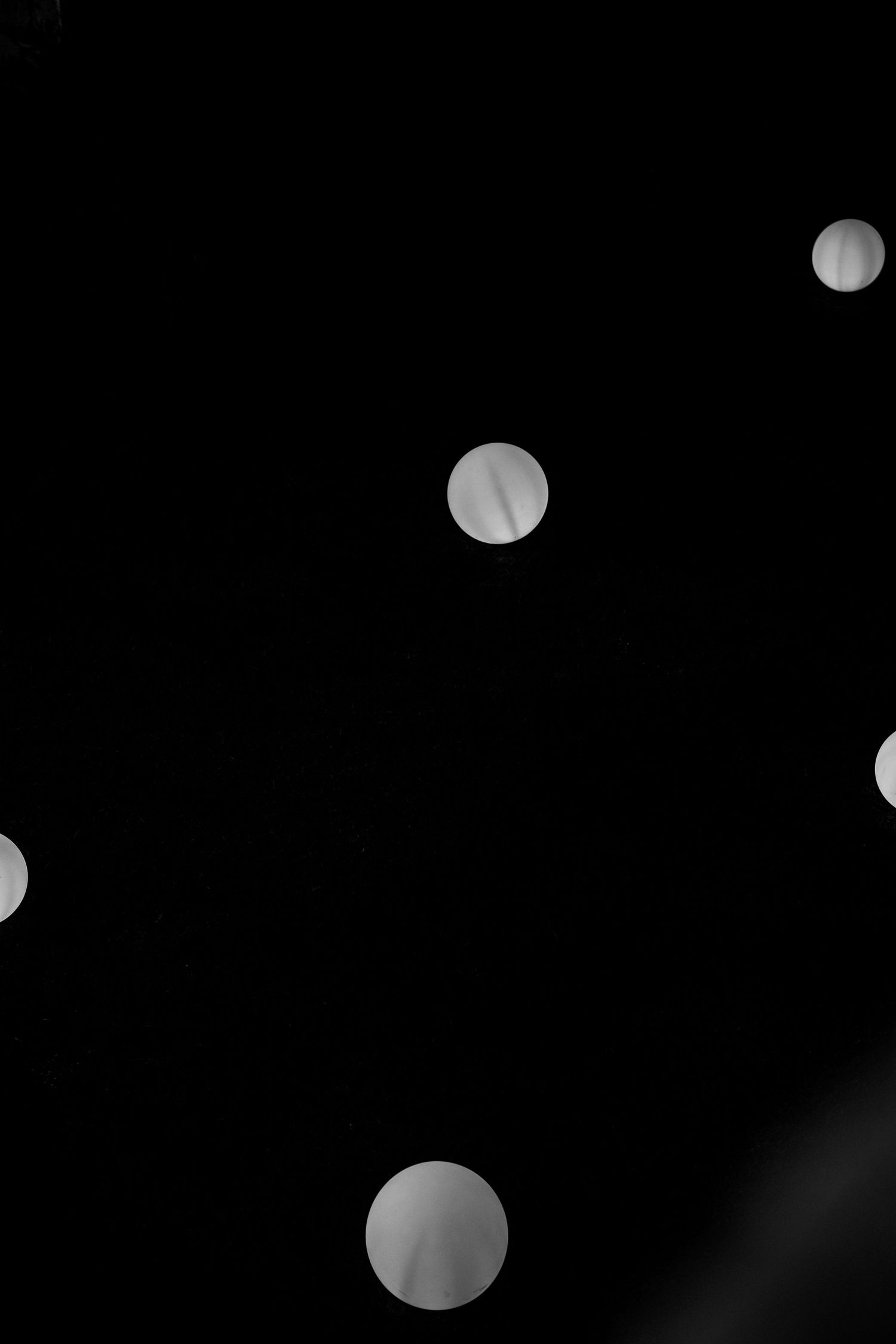Abstract bokeh lights floating against dark background creating dreamy atmosphere.