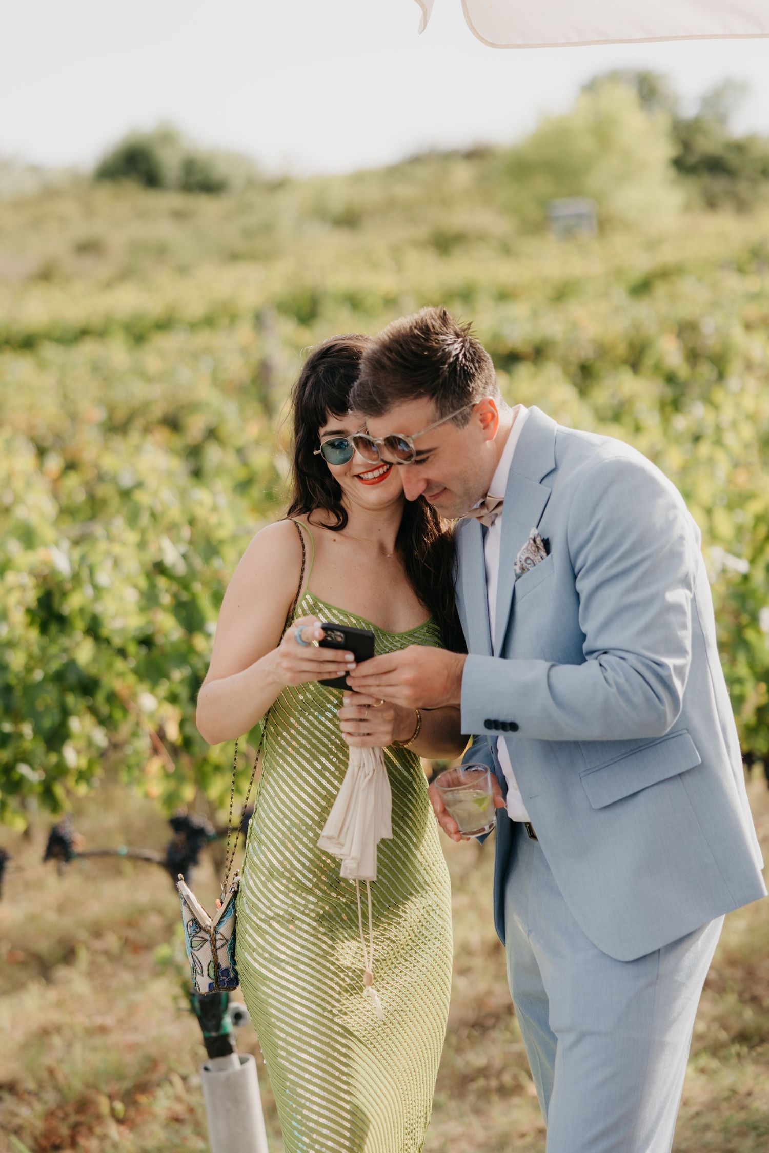 Couple enjoying wine tasting in a scenic vineyard setting in Italy.