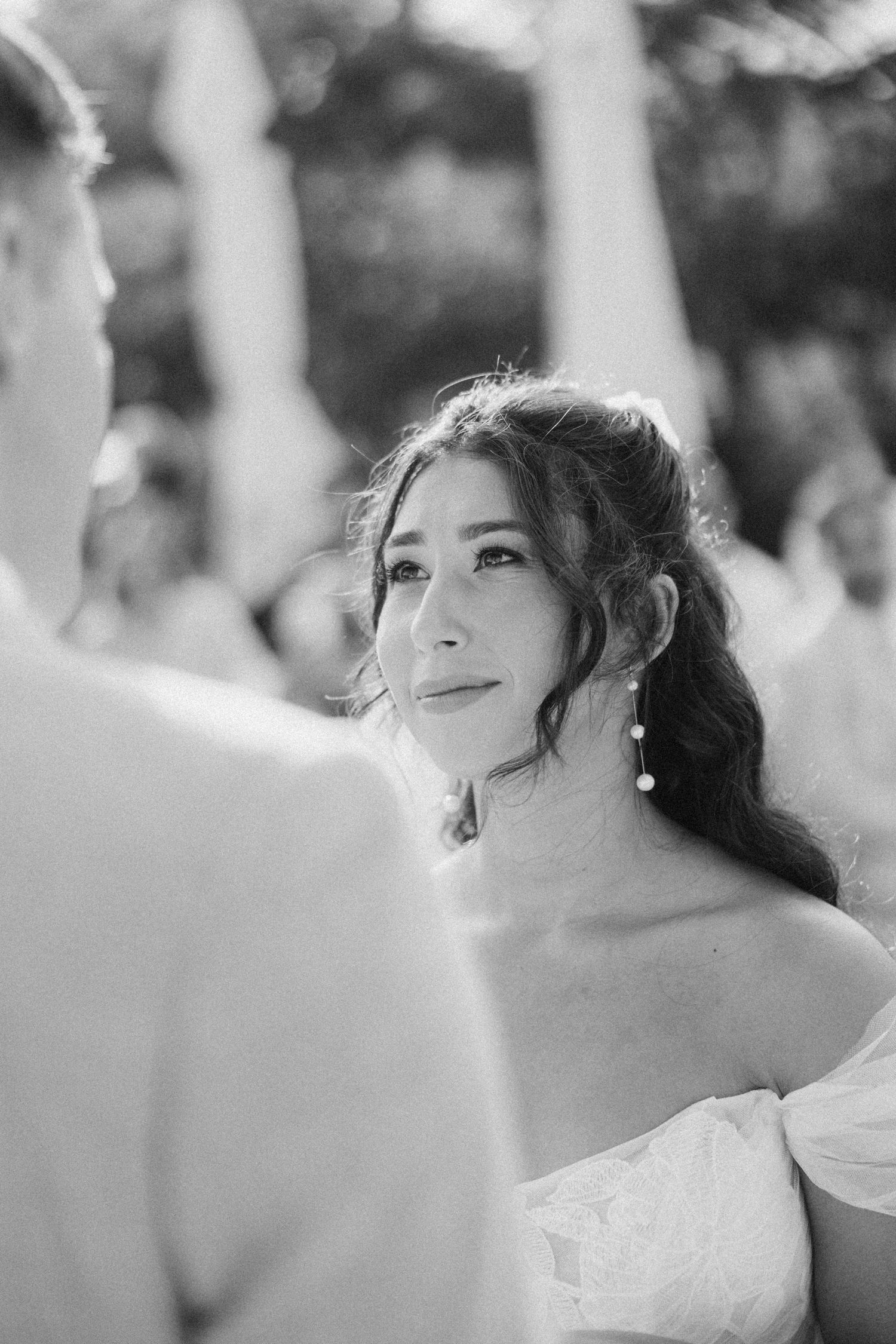 A series of black and white candid moments showing joyful expressions during a wedding ceremony.
