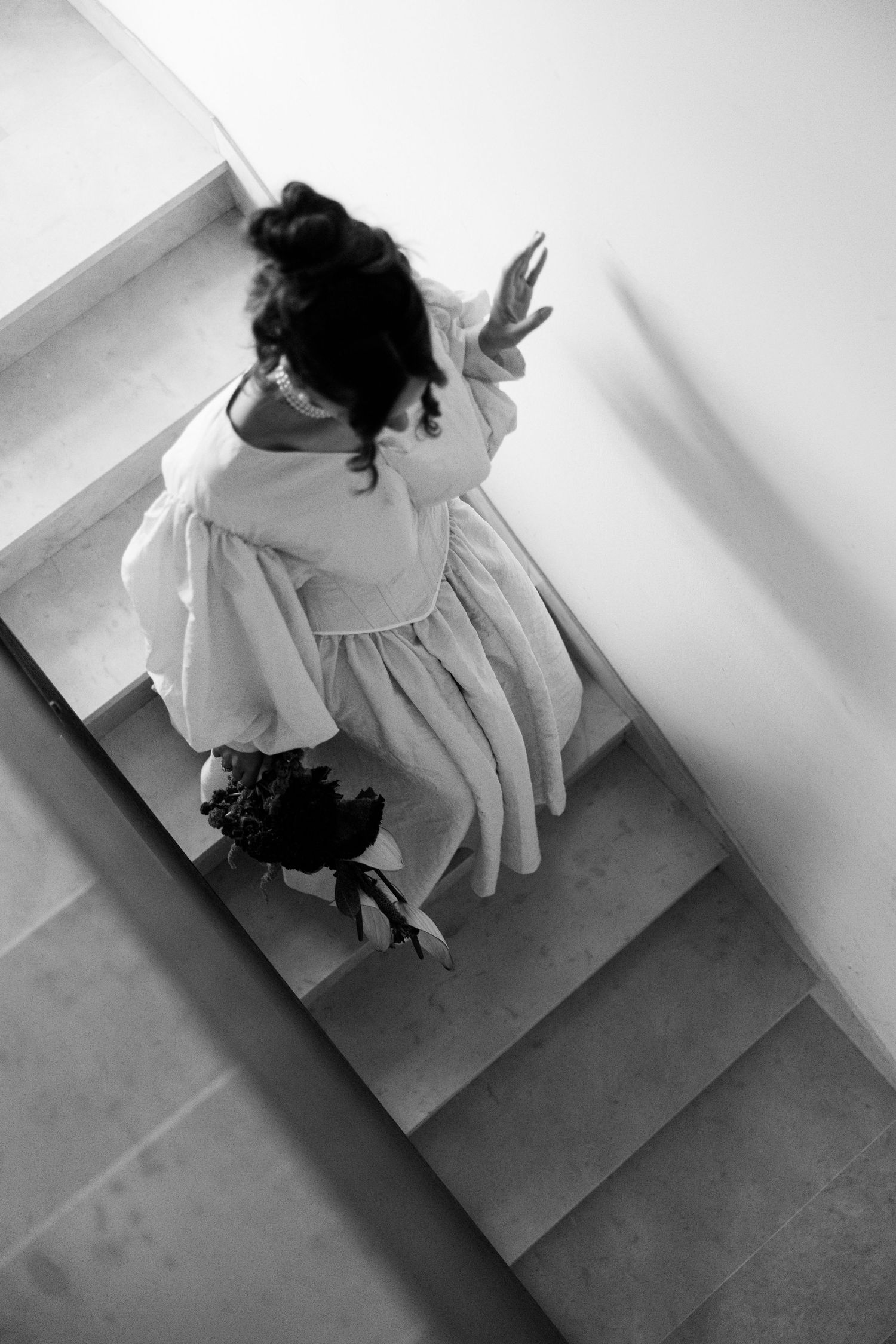 Artistic black and white sequence showing hands and movement against a minimalist background.