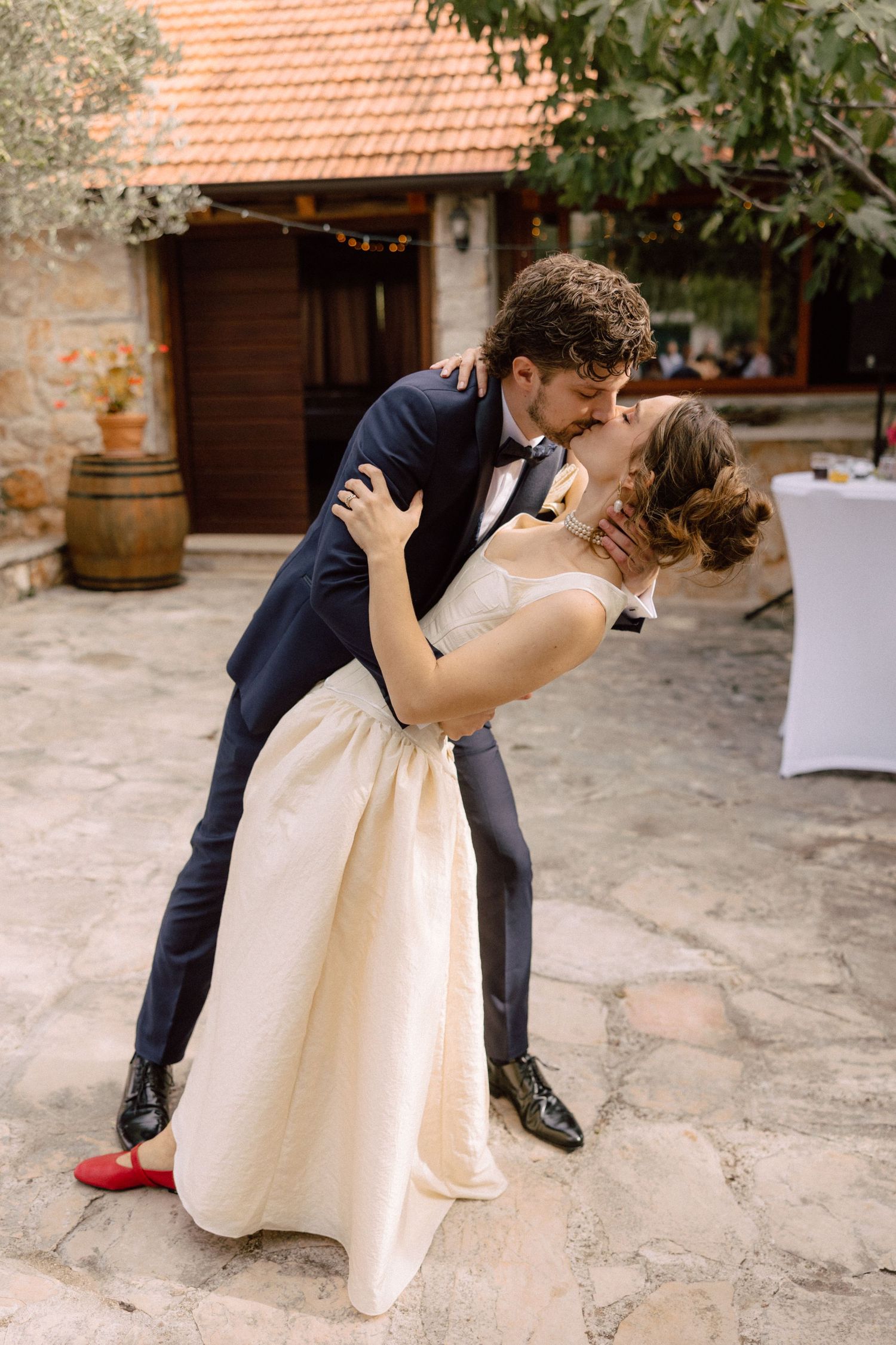 Wedding dance sequence showing romantic dip moves on a stone patio.