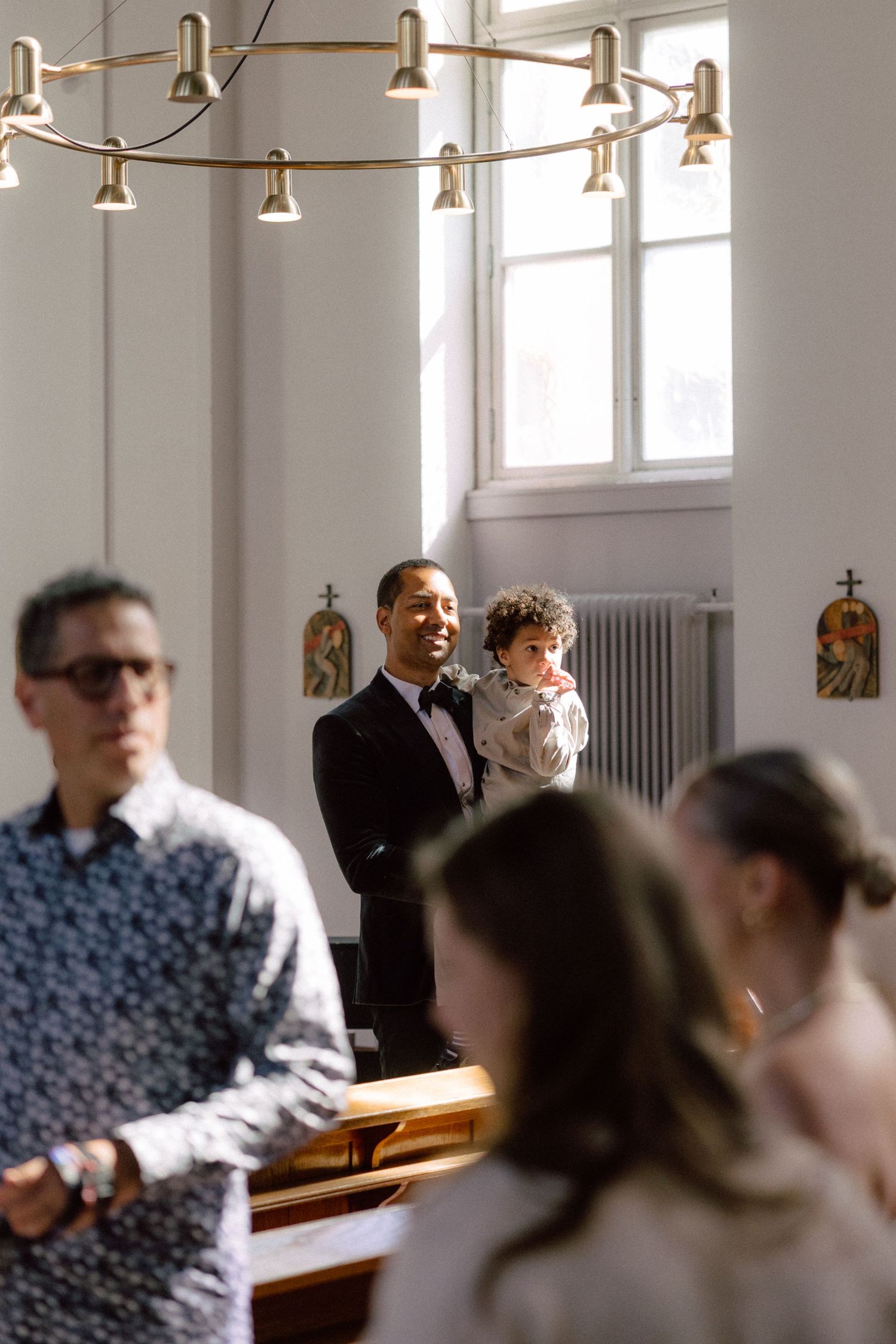 Interior of a bright modern church with hanging pendant lights.