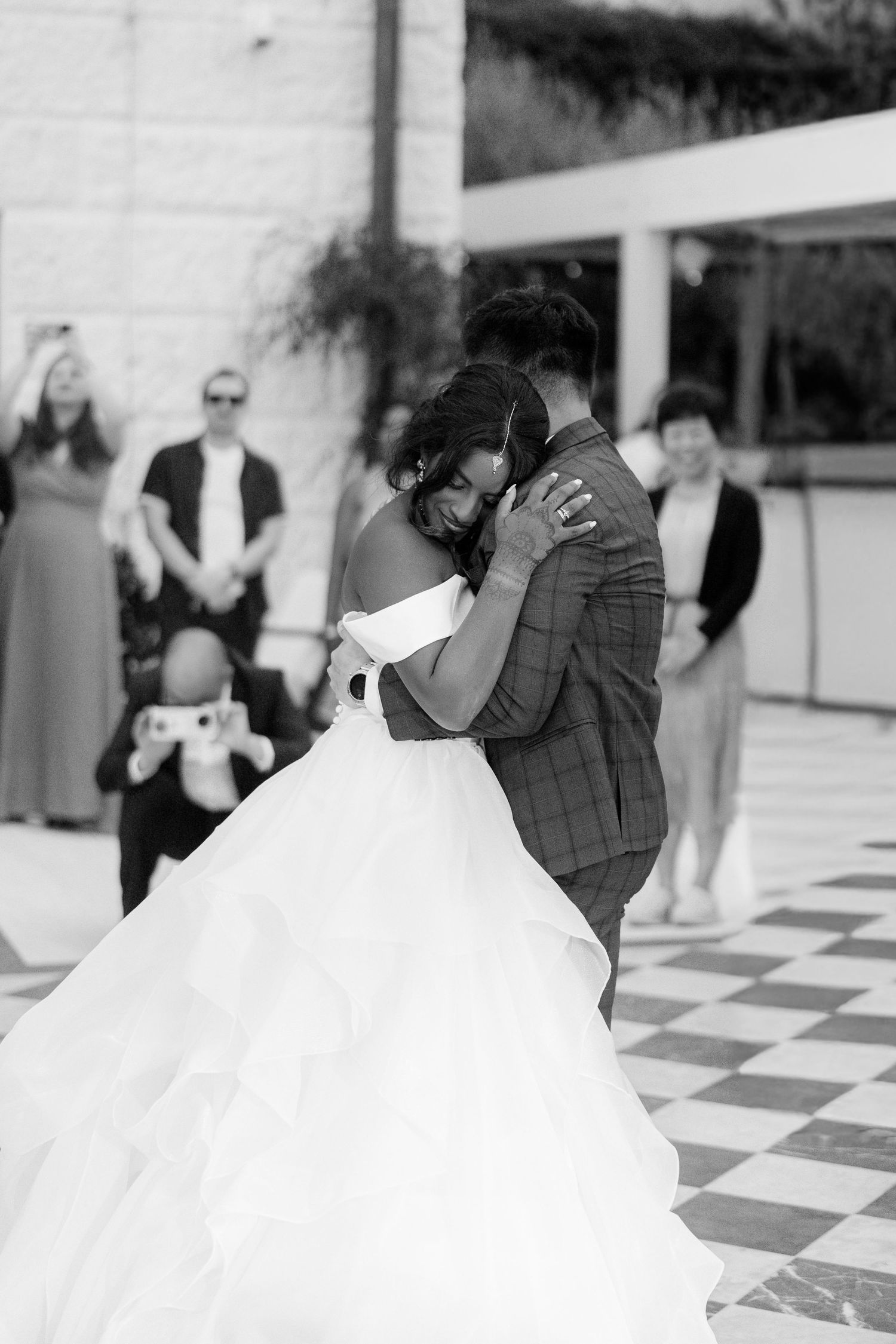 Bride and groom share an intimate first dance in black and white wedding photo.