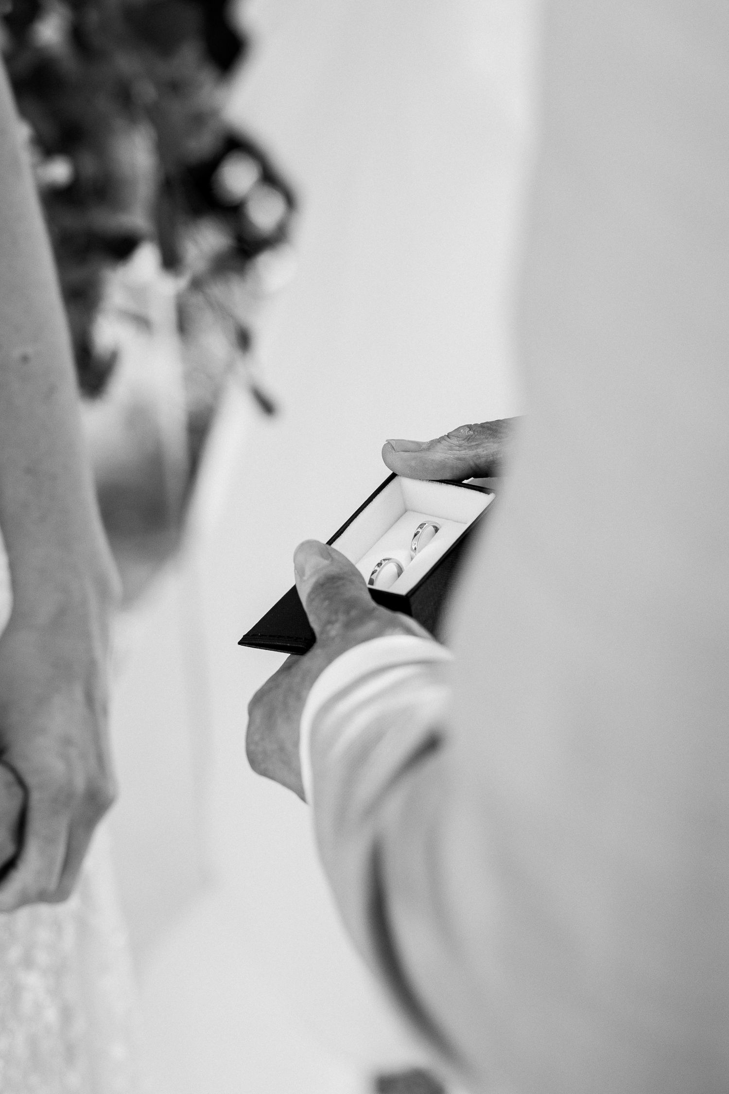 Artistic black and white close-up shots of wedding ceremony details.