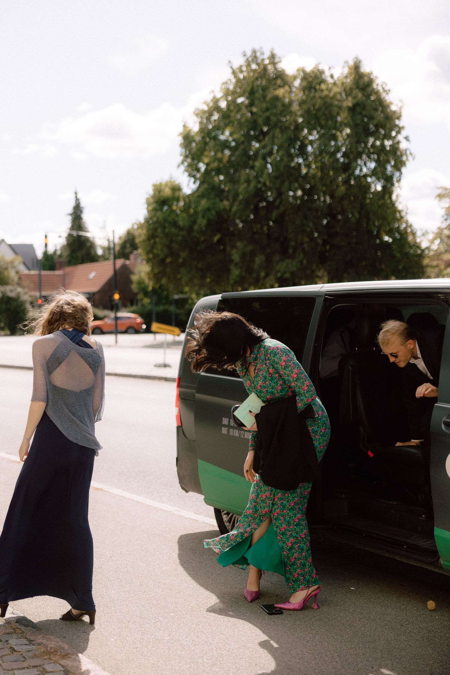 Guests getting into a black limousine after an event.