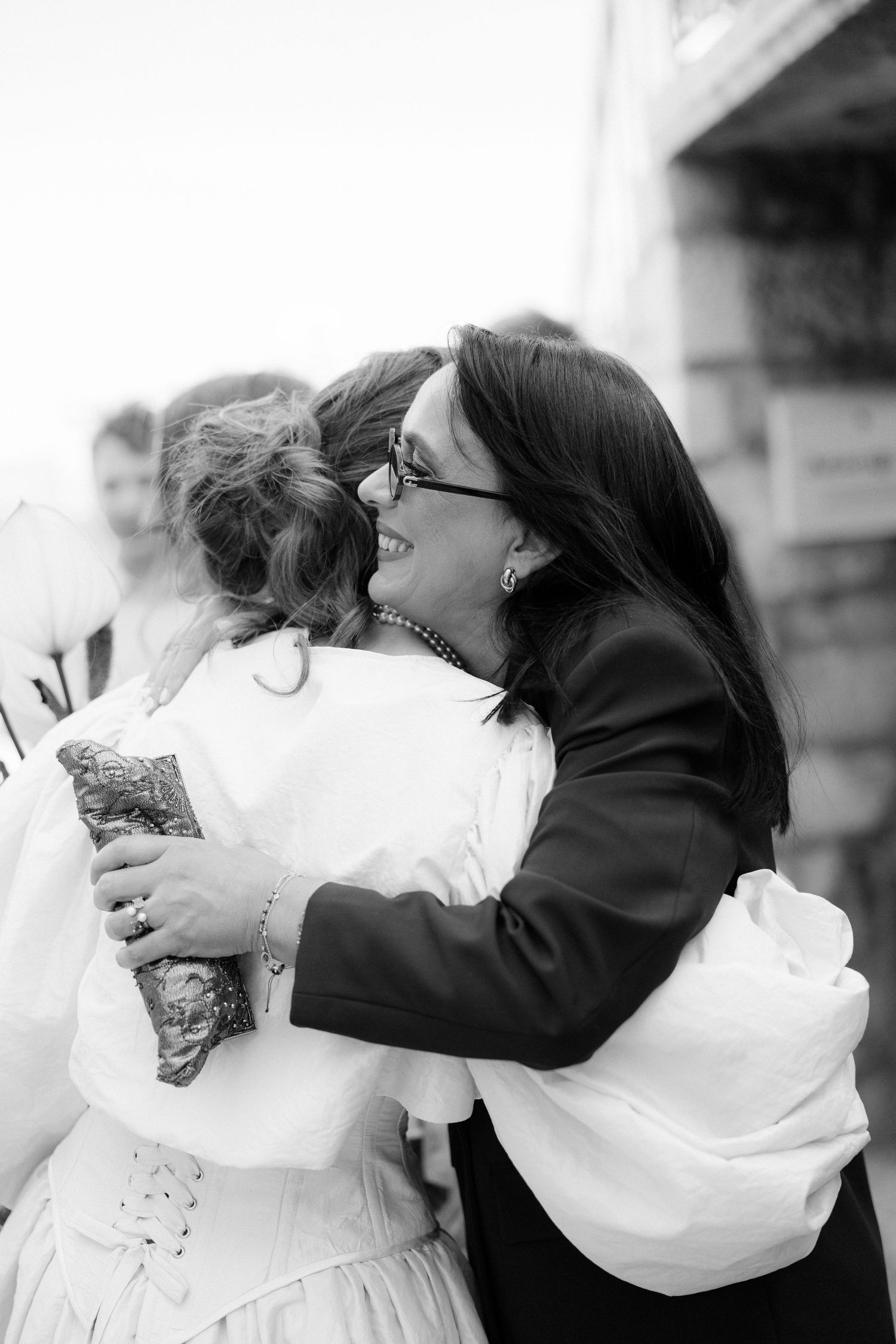 Series of black and white romantic wedding photos showing tender embraces and kisses between a couple.