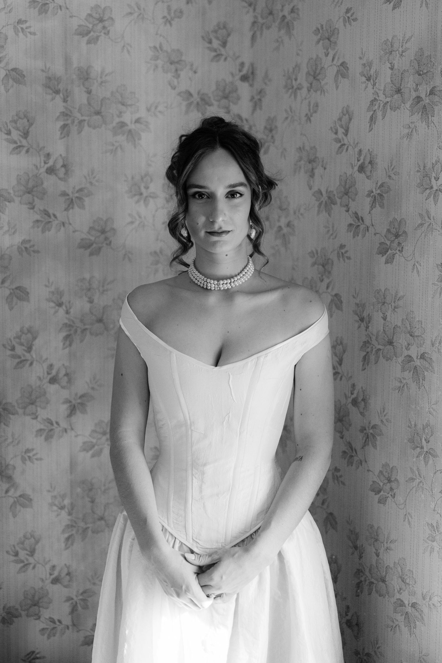 Portrait series showing a white wedding dress against floral wallpaper background.