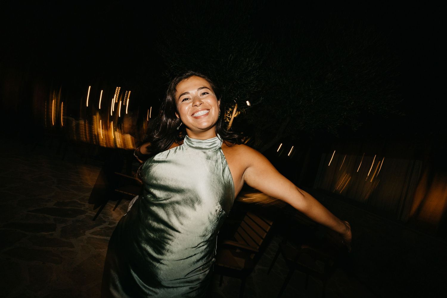 A wedding reception dance floor filled with guests celebrating under dim lighting.