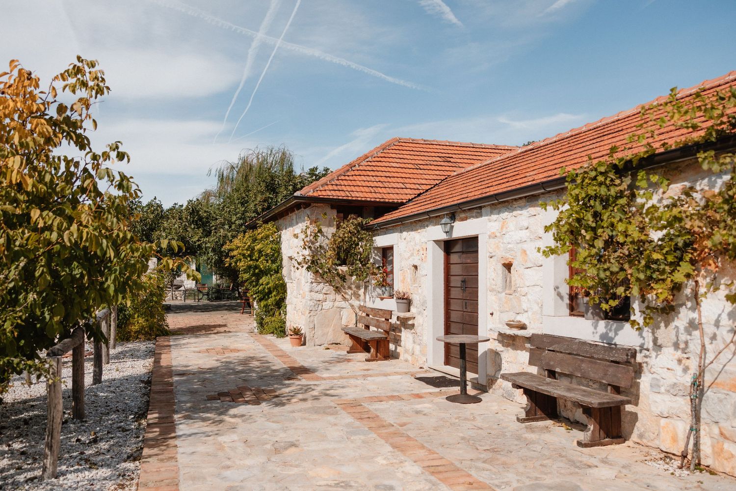 Mediterranean style stone houses with terracotta roofs under blue sky.
