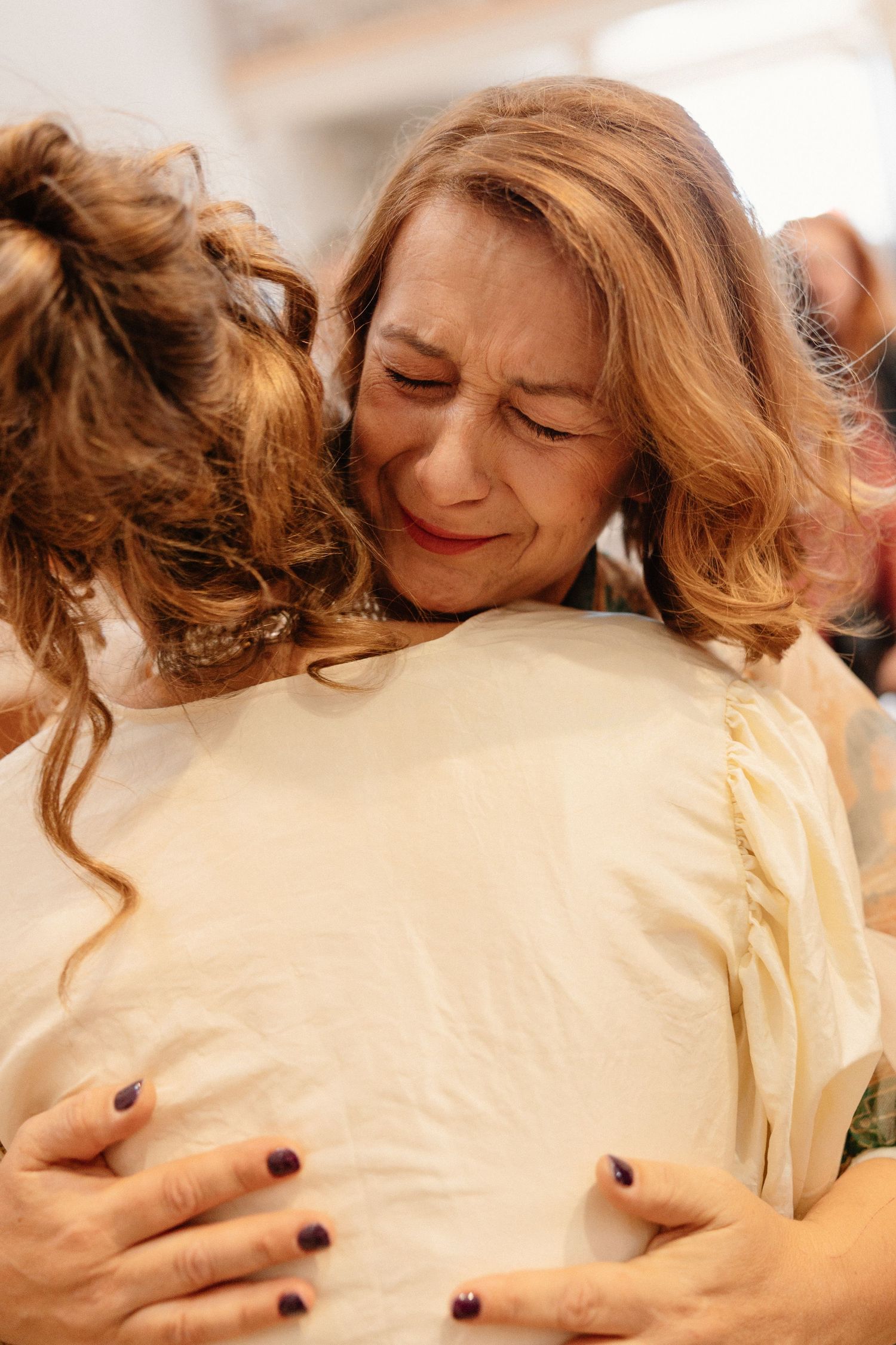 Intimate embrace showing cream-colored dress detail.