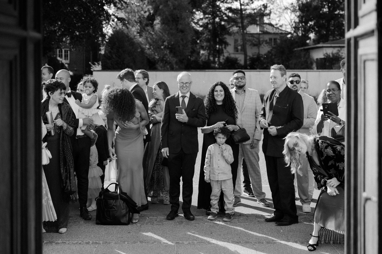 Wedding guests standing outside a church entrance during the celebration.