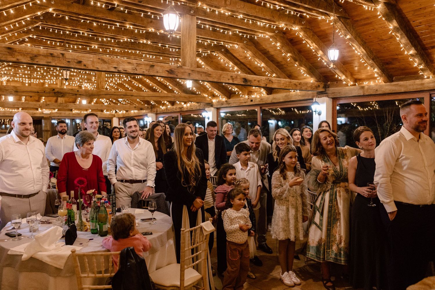 Wedding reception venue decorated with warm string lights creating romantic ambiance.