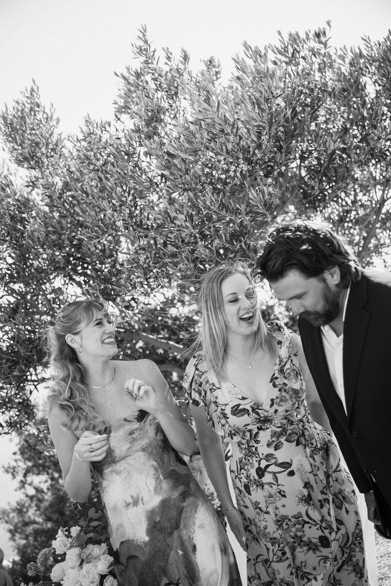 A romantic wedding scene captured among blooming trees and natural greenery.