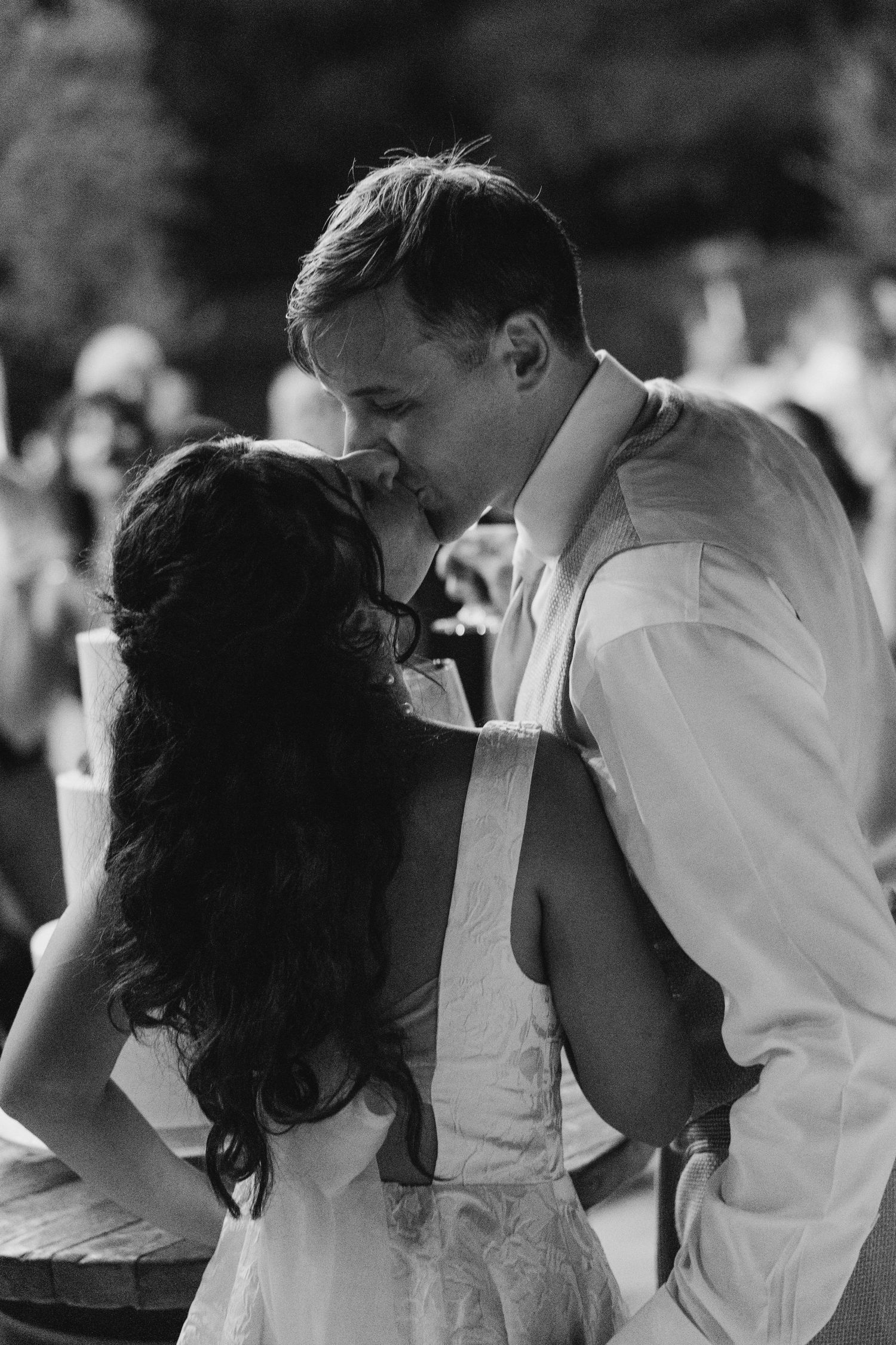 Romantic black and white dance sequence at an outdoor wedding reception.