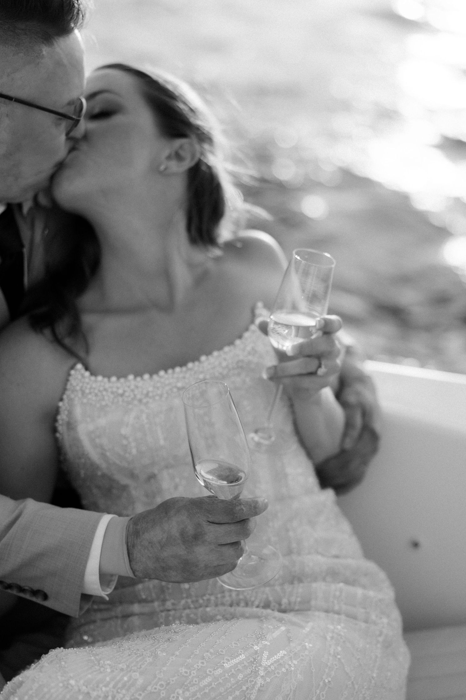 Wedding celebration moment with delicate lace dress and champagne toast.