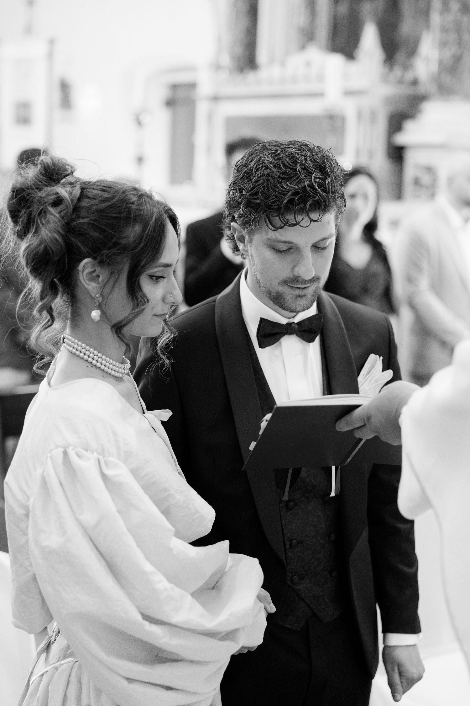 Elegant wedding ceremony with couple in formal attire at church altar.