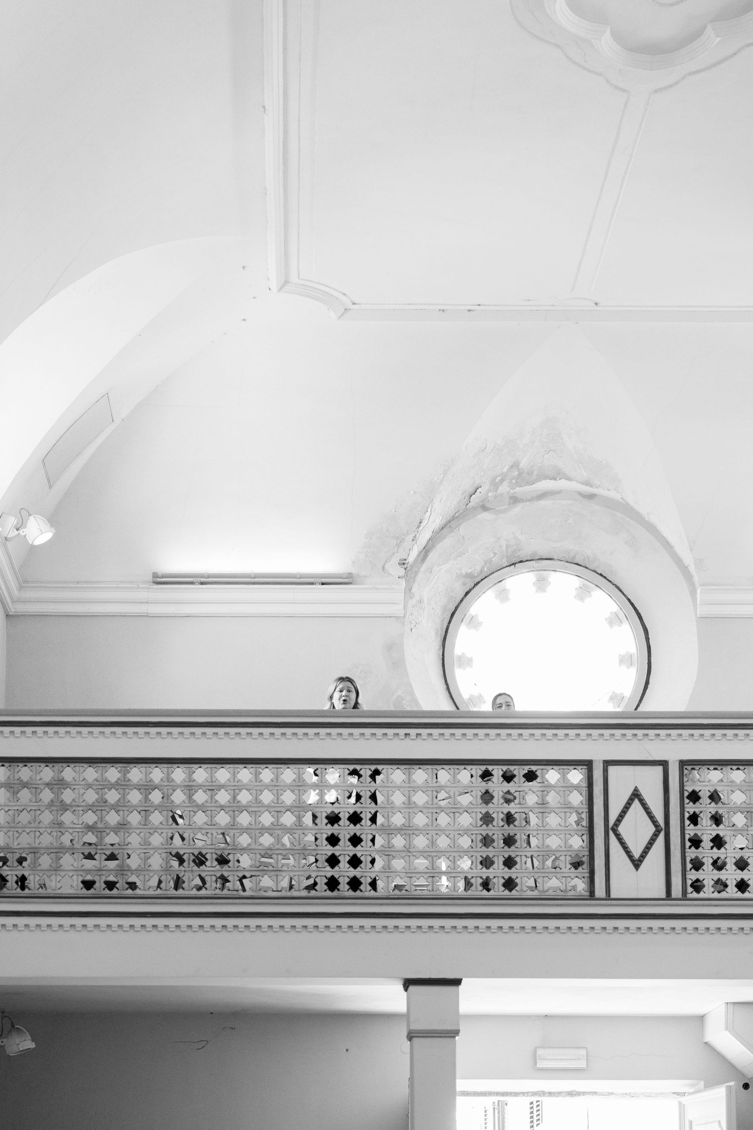 Black and white geometric patterns decorate the wall of a bright interior space.