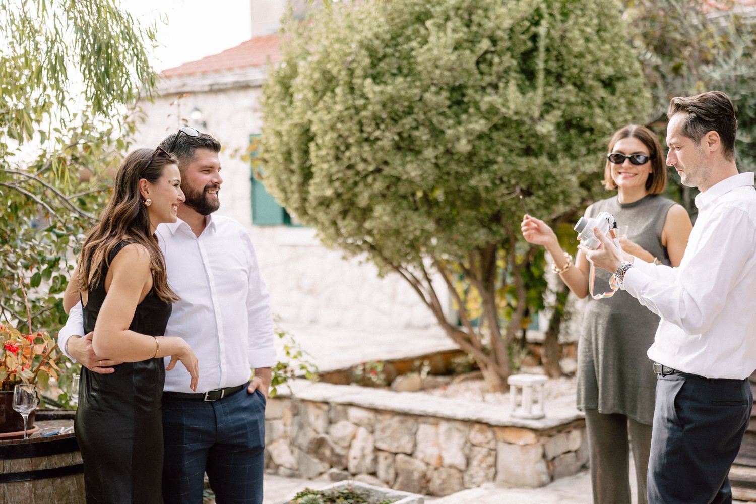 Couple sharing a romantic moment in a sunny outdoor setting.