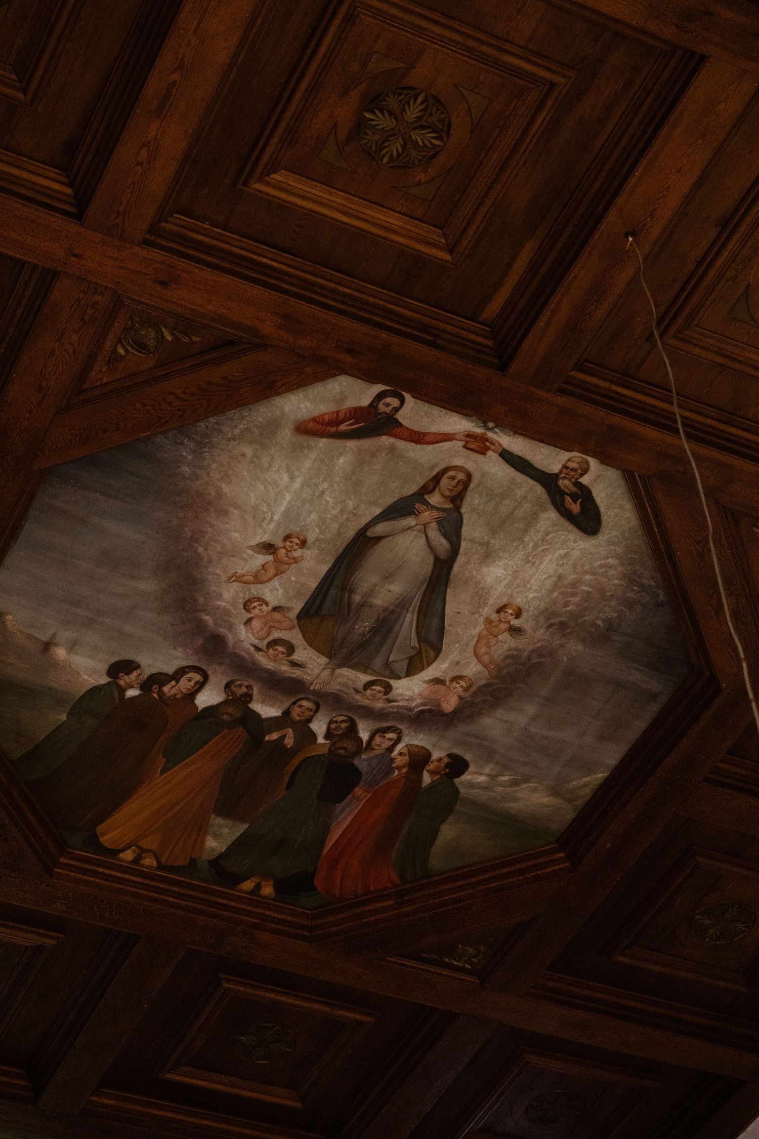 A religious ceiling fresco depicting a divine scene with figures gathered around a central figure.