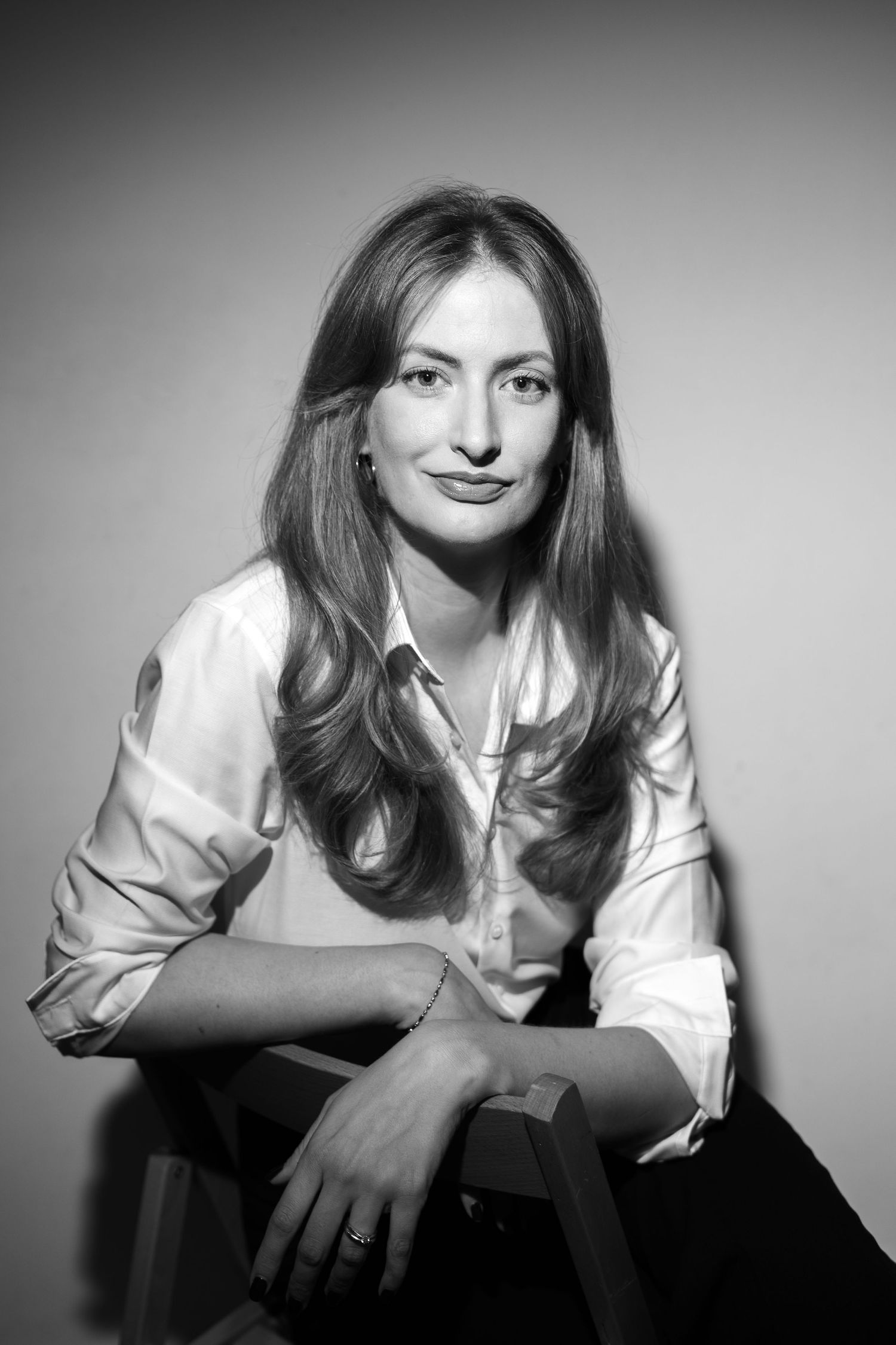 Black and white portrait series showing artistic poses with dramatic lighting and a white shirt against dark background.