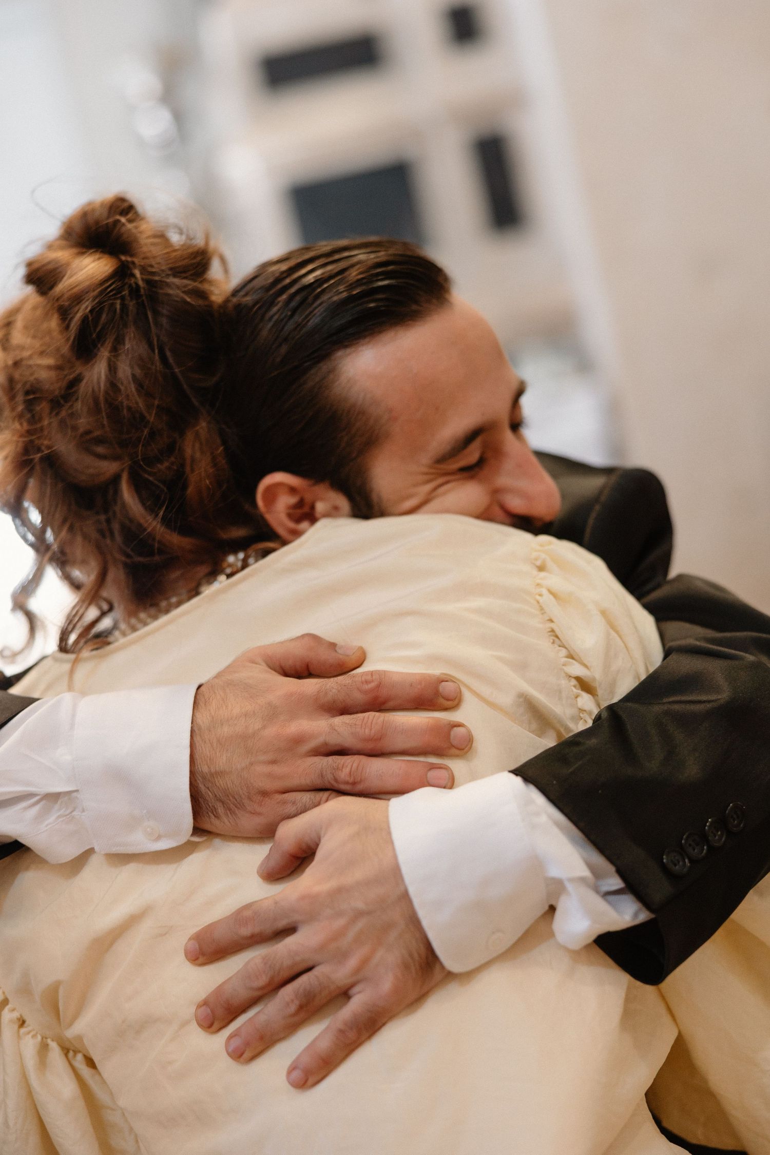 Emotional wedding embrace captured in a sequence of warm-toned photographs.
